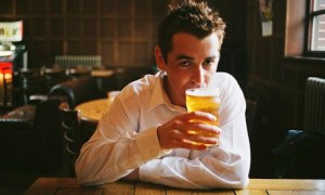 Man drinking pint of beer in pub